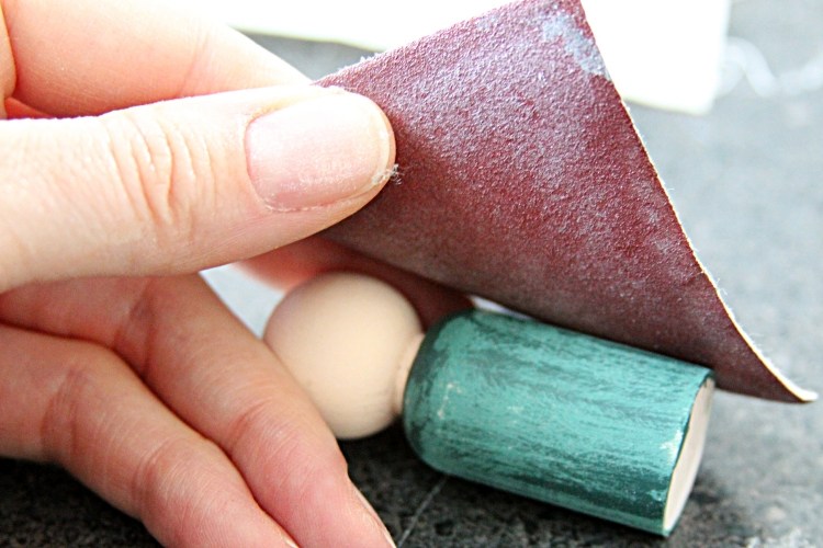 potom, čo je farba úplne suchá, trochu zbrúste vianočné dekorácie-nápady-urob si sám-vianočná postieľka-drevené figúrky-drotár-brúsny papier-farba