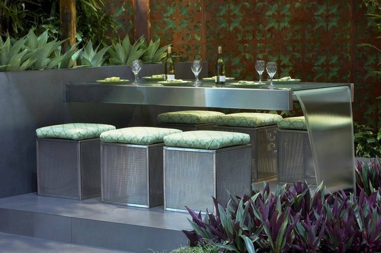 Oceľový jedálenský stôl so taburetkami - chrliče namontované na konci stola chrliče vody v záhrade oceľový jedálenský stôl chrliče vodopádov