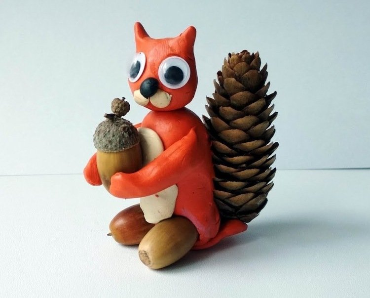 Veveričky z modelovacej hmoty a žaluďov a dlhé smrekové šišky robia nápady pre deti na základnej škole