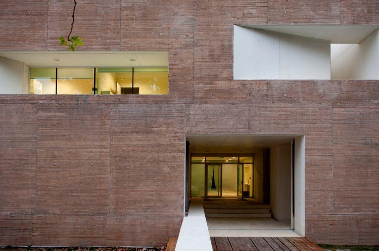 betónová budova s viacerými tvárami betón-architektúra-bielo-červená-piesková-farba-minimalistická