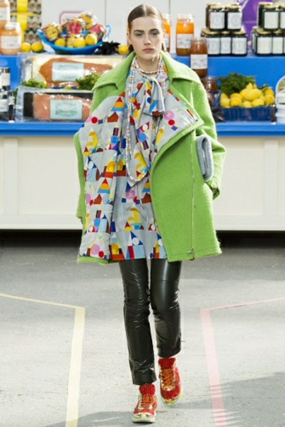 zelený kabát so vzorovanou podšívkou a čiernymi legínami Kabát-s-geometrickými figúrkami-legíny-s-metalickým vzhľadom