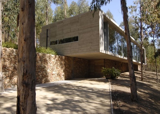 omnibusový dom s kamennou stenou na svahu od pedro gubbinov