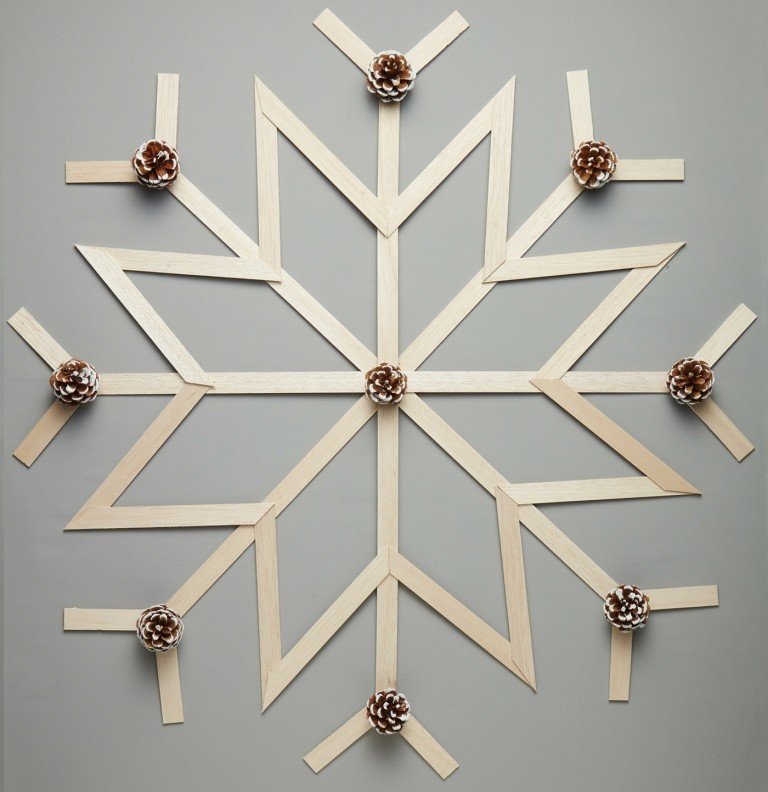 Ručné palice vyrobené z dreva a malých šišiek na snehovú vločku