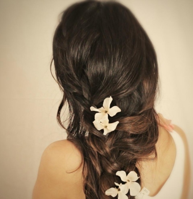 Vlasy zapletené do ležérneho vrkoča s kvetmi svadobný účes-tvorba-čiernych vlasov-vrkoč