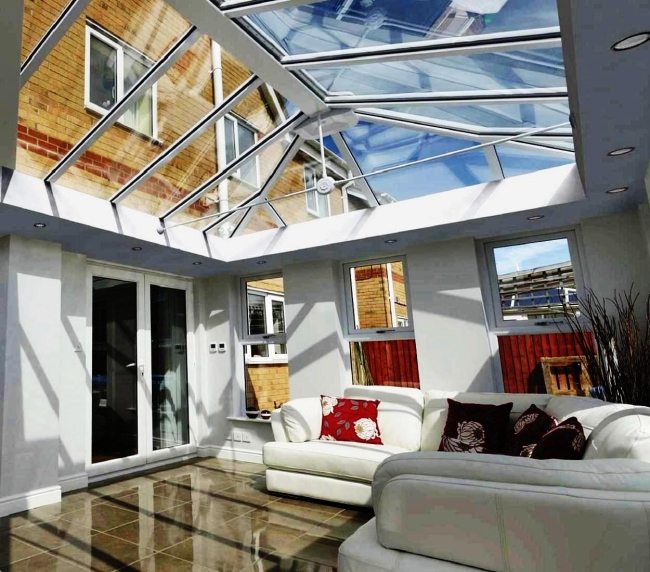 obývacia izba zimná záhrada presklená strecha slnečné svetlo kožená sedačka dlažba