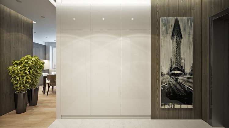 Dizajn chodby - biela vstavaná skriňa a tmavé drevené panely zariadenie-prírodné-tóny-mestská chodba-biela-vstavaná skriňa-rastliny v črepníku