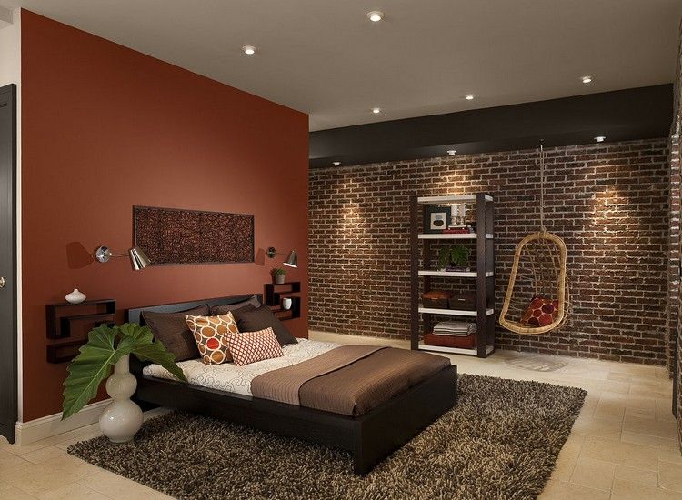 Zemité farby v spálni - tehlovočervená, béžová a hnedá color-design-bedroom-earth-colored-brown-visiace kreslo-podlaha z prírodného kameňa