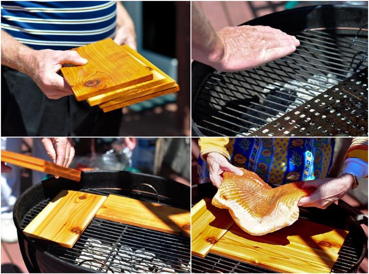 Grilovaný filet z lososa. Doska z cédrového dreva. Gril na drevené uhlie