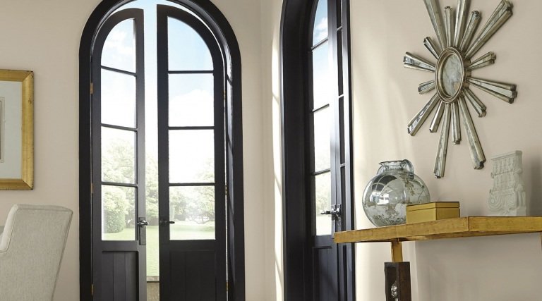 Čierne dvere a stena zo slonoviny a odkladací stolík so zlatými nohami