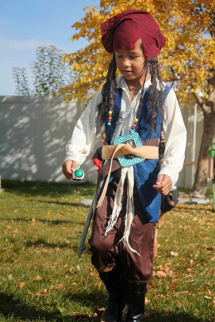 Krojovaný chlapec kráča s lyžicou a plastovou očnou buľvou halloween-hry-pirát-dvor-chlapec-závod-očná guľa