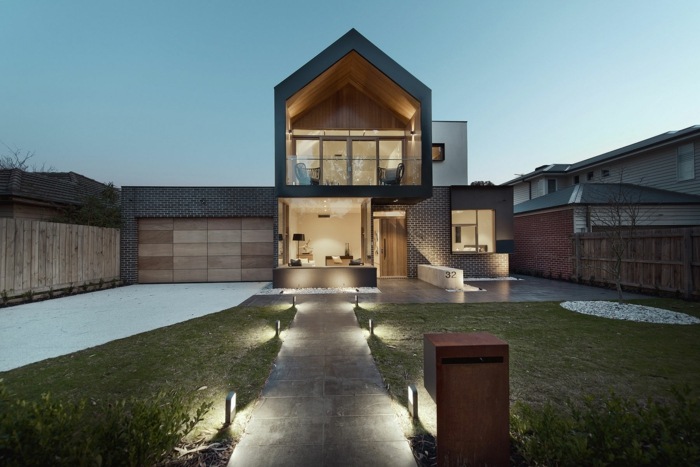 Dom v Melbourne so svetlami večer dizajn domu z melbournskej architektúry moderné predné osvetlenie trávnika