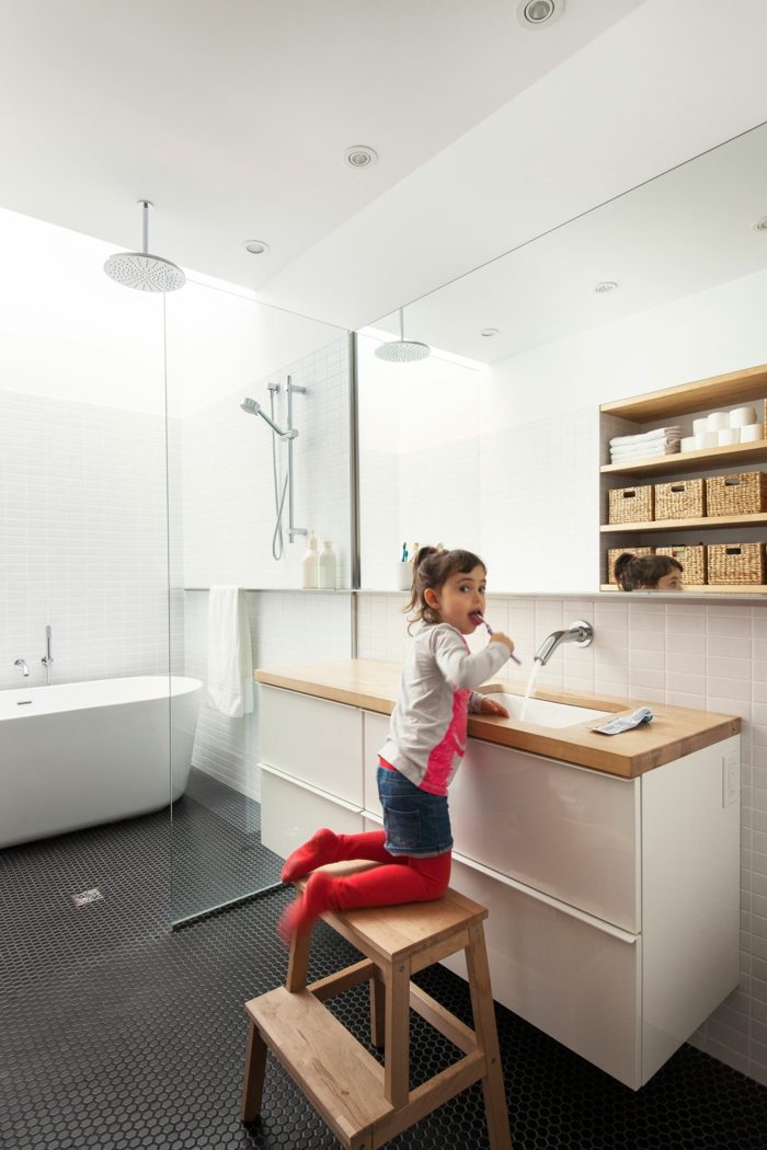 Svetlý dizajn kúpeľne s bielymi obkladačkami a čiernou mozaikovou podlahou dizajn domu kúpeľňové umývadlo vaňa sprchovací kút