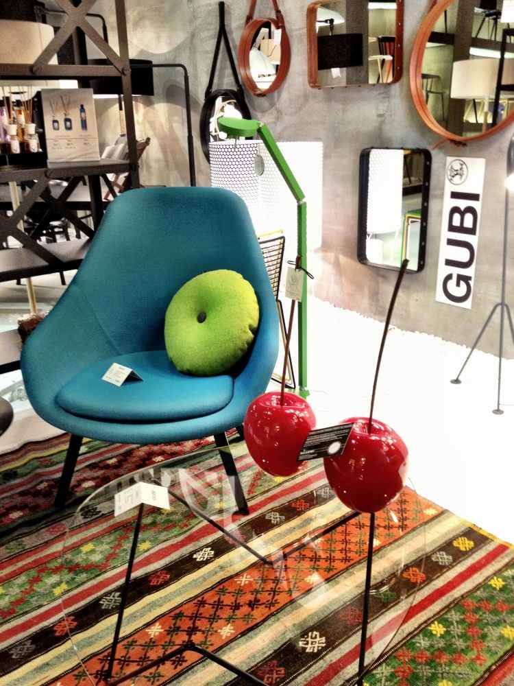 Farby medzi sebou komunikujú Kilim-koberec-moderné-kreslo-tyrkysovo-dekoratívne-jablká-plastové-sklenené-stolné-predmety