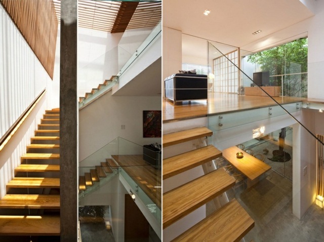 Moderná mestská vila so skleneným zábradlím s interiérovým zariadením na nádvorí