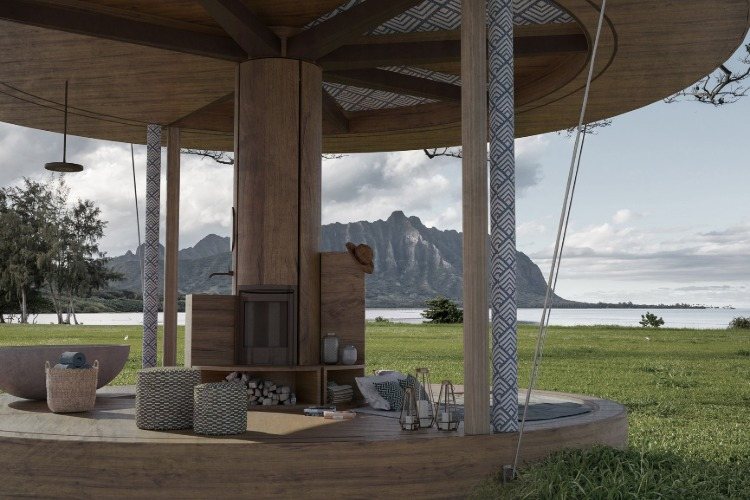 vonkajší priestor s trávnikom a krásnym výhľadom na more pre okrúhly drevený dom so stĺpmi a strechou