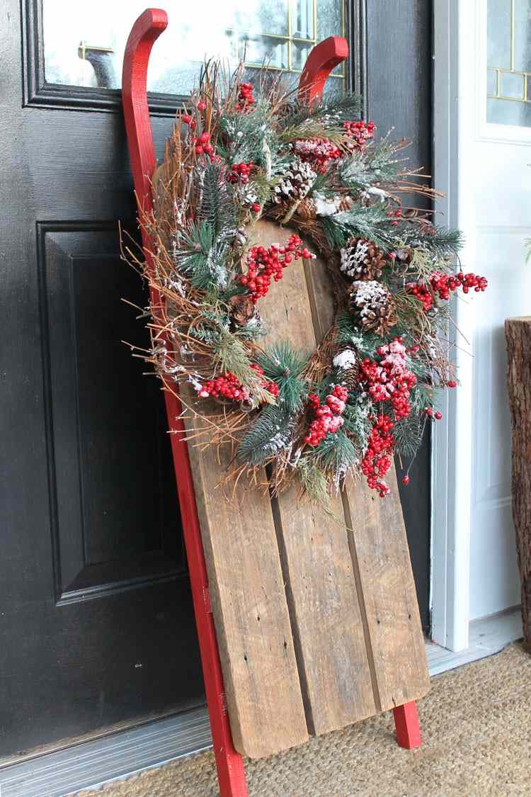 Sánky na Vianoce zdobia veniec prírodný materiál