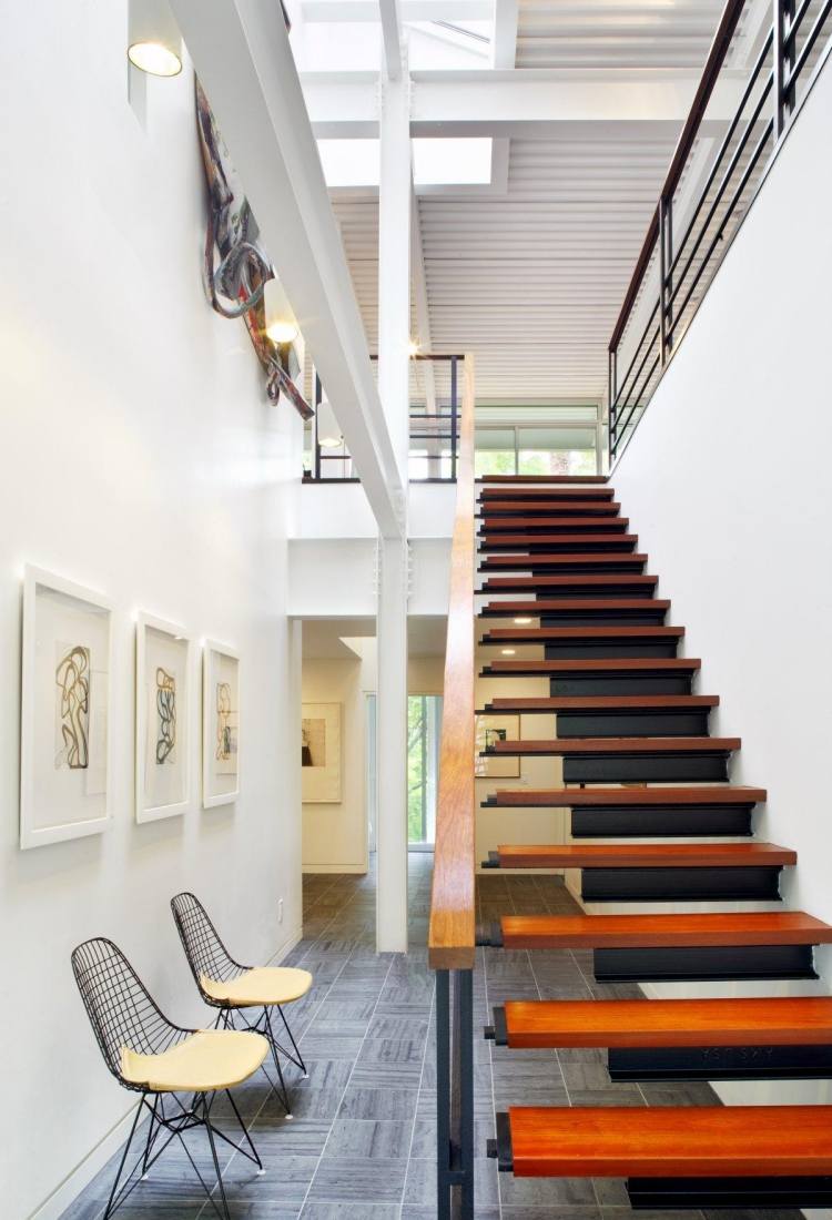Drevené schodisko s madlom a zaistené oceľou plávajúce schody-drevené zábradlie-stena-kov-dom-otvorený-strop-stoličky