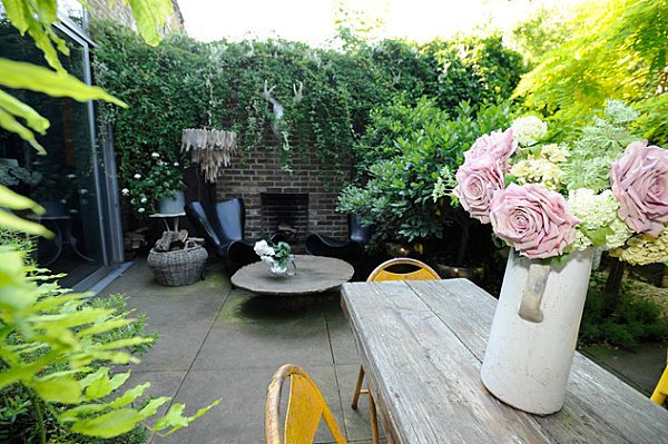 štýlové záhradné stoličky váza na kvety drevený stôl záhradný nábytok sklenené dvere Kovové záhradné stoličky-drevené stoly-kvetináče-kamenná podlaha