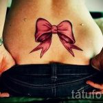 íj tetoválás a hát alsó részén - fényképes példa a kész tetoválásra 02052016 1