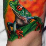 Béka tetoválás - szelén fényes szemekkel narancssárga alapon