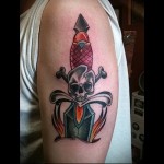 tetováló kés a kezében és a koponyában