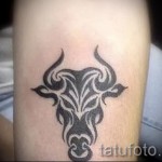 A kész tetoválás a csillagjegy bika - fotó a törzsi minták férfiakról