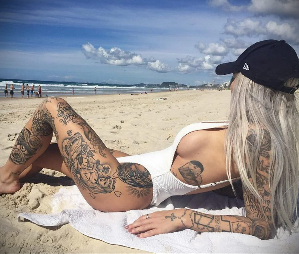 man with tattoo on the beach - photo 2