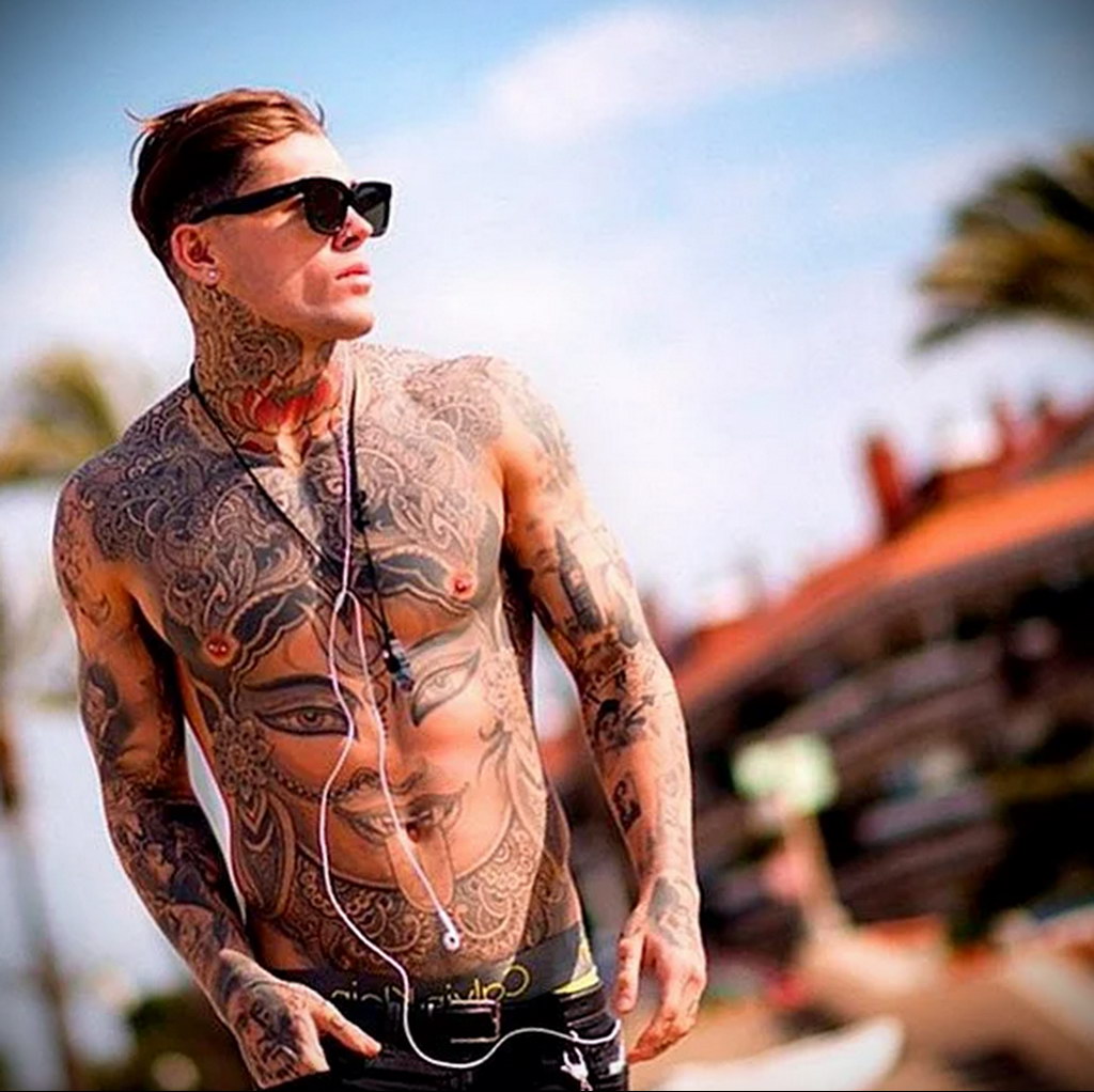 man with tattoo on the beach - photo 3