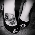 koponya virággal a hajában - tetoválás a lány lábának alsó részén