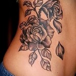 kwiat róży z opadającymi płatkami - kobiecy tatuaż z boku