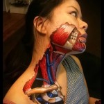 tetoválás a lány arcán, aki megmutatja a bőr alatti izmokat