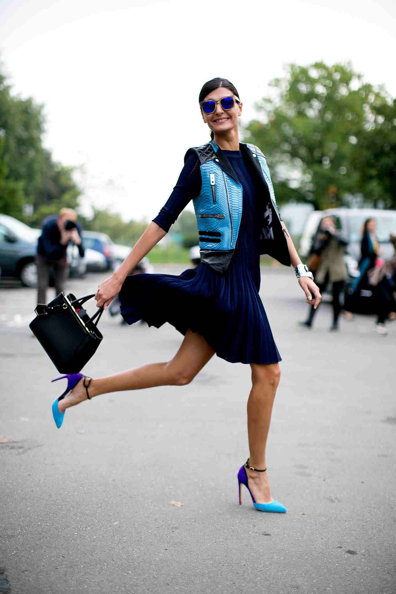 Kožená vesta kombinuje módne trendy plisovanej sukne s vysokým podpätkom a vzorom hada