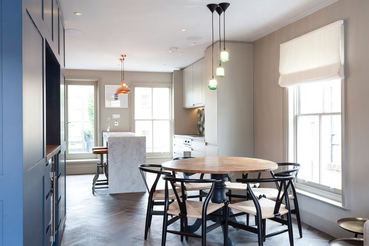 stolička na kosenie kostí ikonická stolička hans wegner dánsky dizajn okrúhly jedálenský stôl kuchyňa kuchynský ostrov závesné žiarovky biela čierna béžová