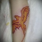 tűz madár tetoválás repülés közben a lábán
