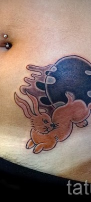 Снимка на заешка татуировка в долната част на корема на момиче - интимна татуировка в зоната на бикините